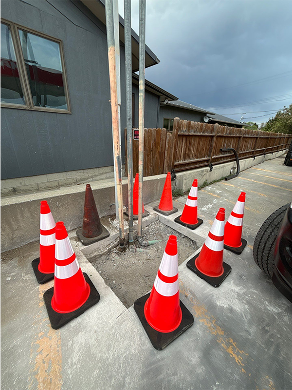 Vent Lines Exposed for Repair Vent Line Repair Progress : Safety cones surrounding vent pipes